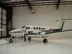 Twin-engine aircraft parked inside a hangar